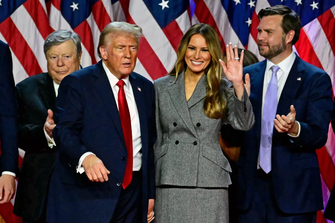 El expresidente de Estados Unidos y candidato presidencial republicano Donald Trump hace un gesto a sus seguidores después de hablar mientras toma de la mano a la exprimera dama de Estados Unidos Melania Trump durante un evento de la noche de las elecciones en el Centro de Convenciones de West Palm Beach en West Palm Beach, Florida, a principios del 6 de noviembre de 2024